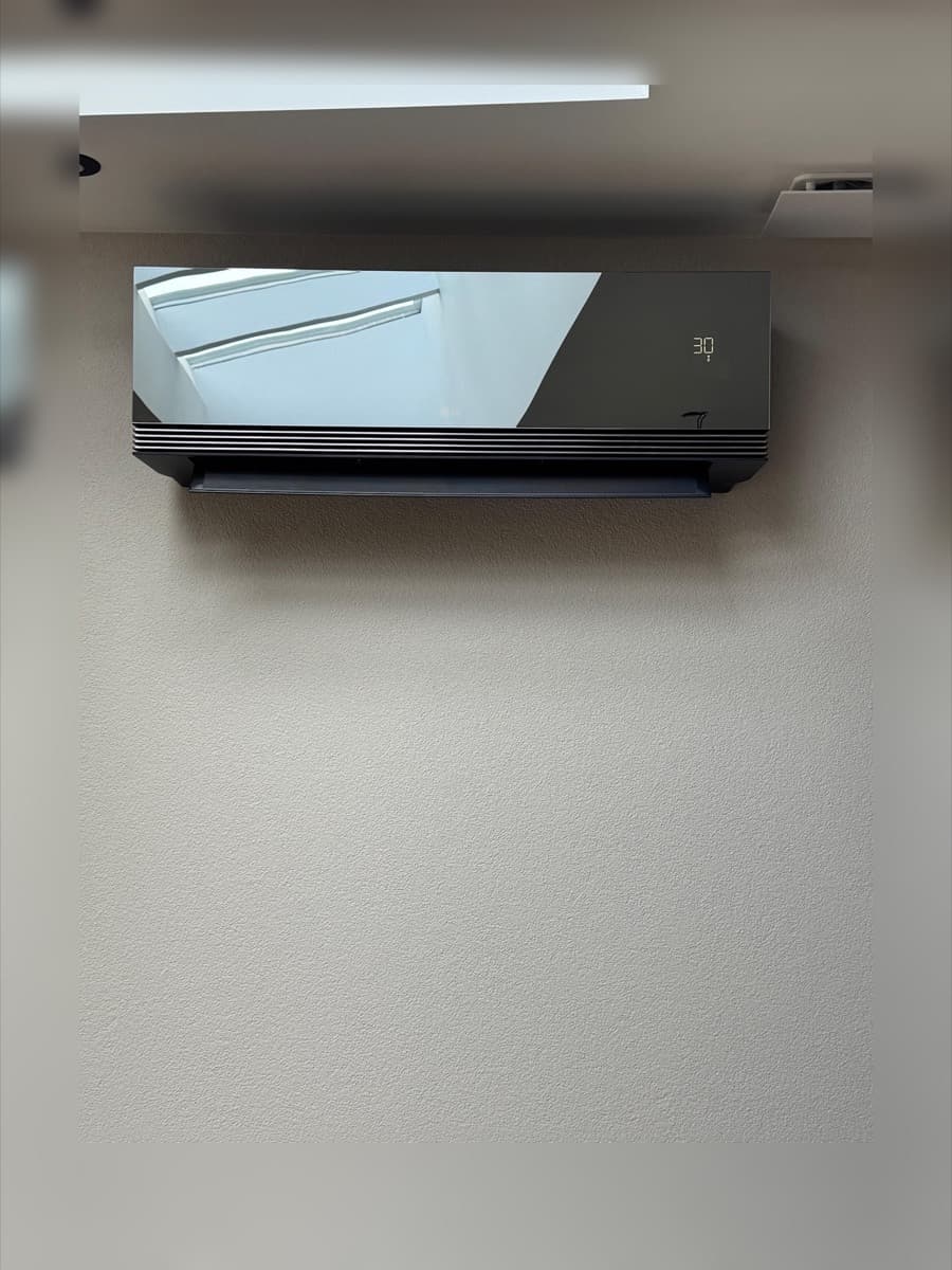 Donkere LG binnenunit strak geplaatst in een kantoorruimte